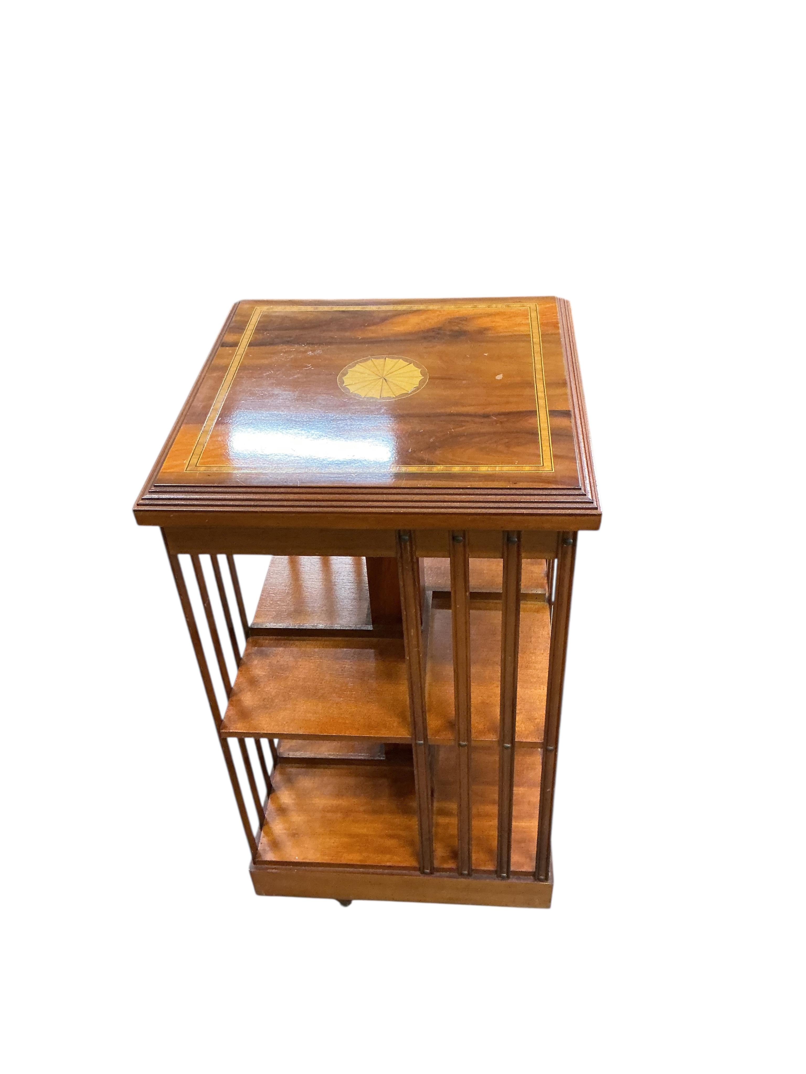 A reproduction square inlaid yew revolving bookcase, width 45cm, height 85cm, together with a reproduction Spanish style two door hardwood cabinet